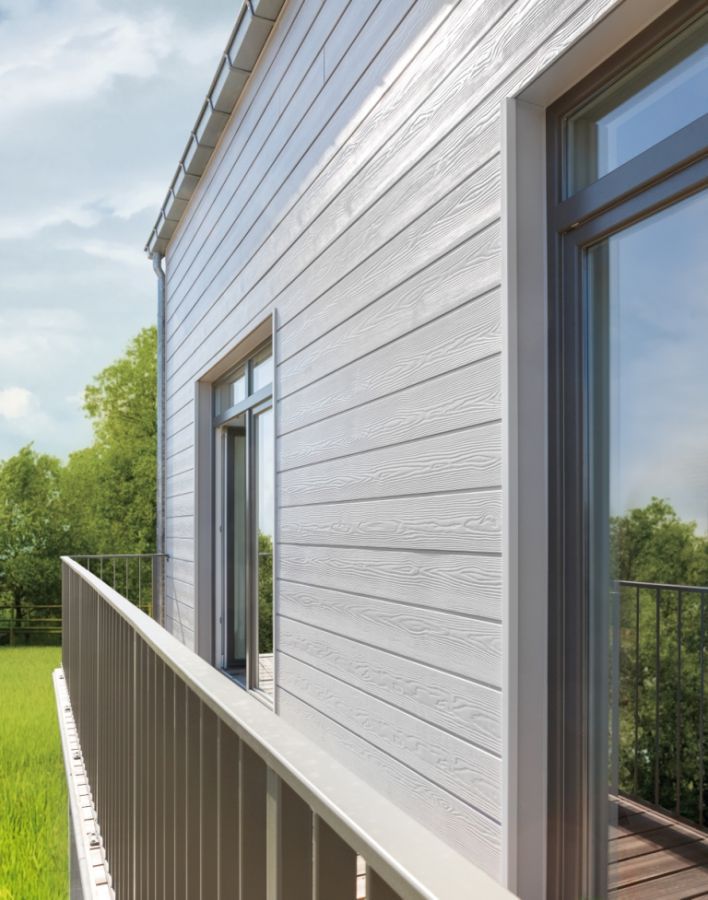 О фиброцементом сайдинге Cedral (Кедрал) Фиброцементный сайдинг Eternit CedralЧем популярен Eternit Cedral: в его основе нет асбеста, материал абсолютно экологичен; обеспечивается огнеустойчивость, благодаря негорючести панелей; снижение теплопотерь, что обеспечит экономию на отоплении дома; монтаж можно производить в любой сезон ( в т. ч. зимой), сайдинг не потеряет свои полезные свойства; установкой можно заниматься самостоятельно, нет необходимости вызывать бригаду рабочих; производитель даёт гарантию сохранения цвета, обеспечена долговечность материала. О коллекциях Eternit - Cedral и Cedral Click Кедрал и Кедрал Клик представляют собой коллекции сайдинга, стилизованные под дерево, натуральный кедр. Простая гладкая фактура передаёт насыщенность цвета. Фактура под дерево практически повторяет все линии кедрового среза. Оба варианта богато выглядят и украсят здание. Коллекция Click отличается тем, что конструкция сайдинга имеет замок. Не обязательно покупать Кедрал древесного цвета, есть и хорошие альтернативы. В цветовой гамме присутствуют минеральные и песочные тона. Фасадный дизайн может быть выполнен в светлых и тёмных тонах. Есть более 10 различных оттенков, которые понравятся даже самому взыскательному покупателю. Деревянная фактура и бетонная прочность сделали сайдинг Eternit Cedral очень востребованным.