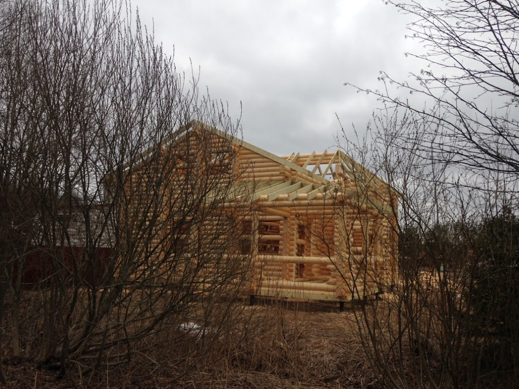 Дом из оцилиндрованного бревна с кровлей из битумной черепицы